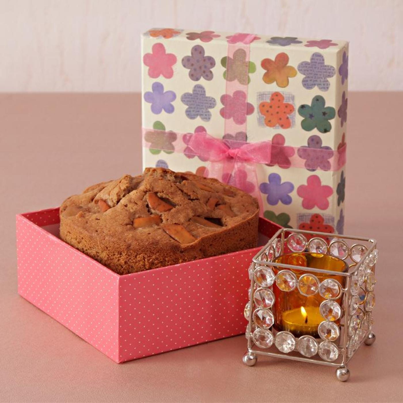 cinnamon cake with crystal votive and christmas decor in gift
