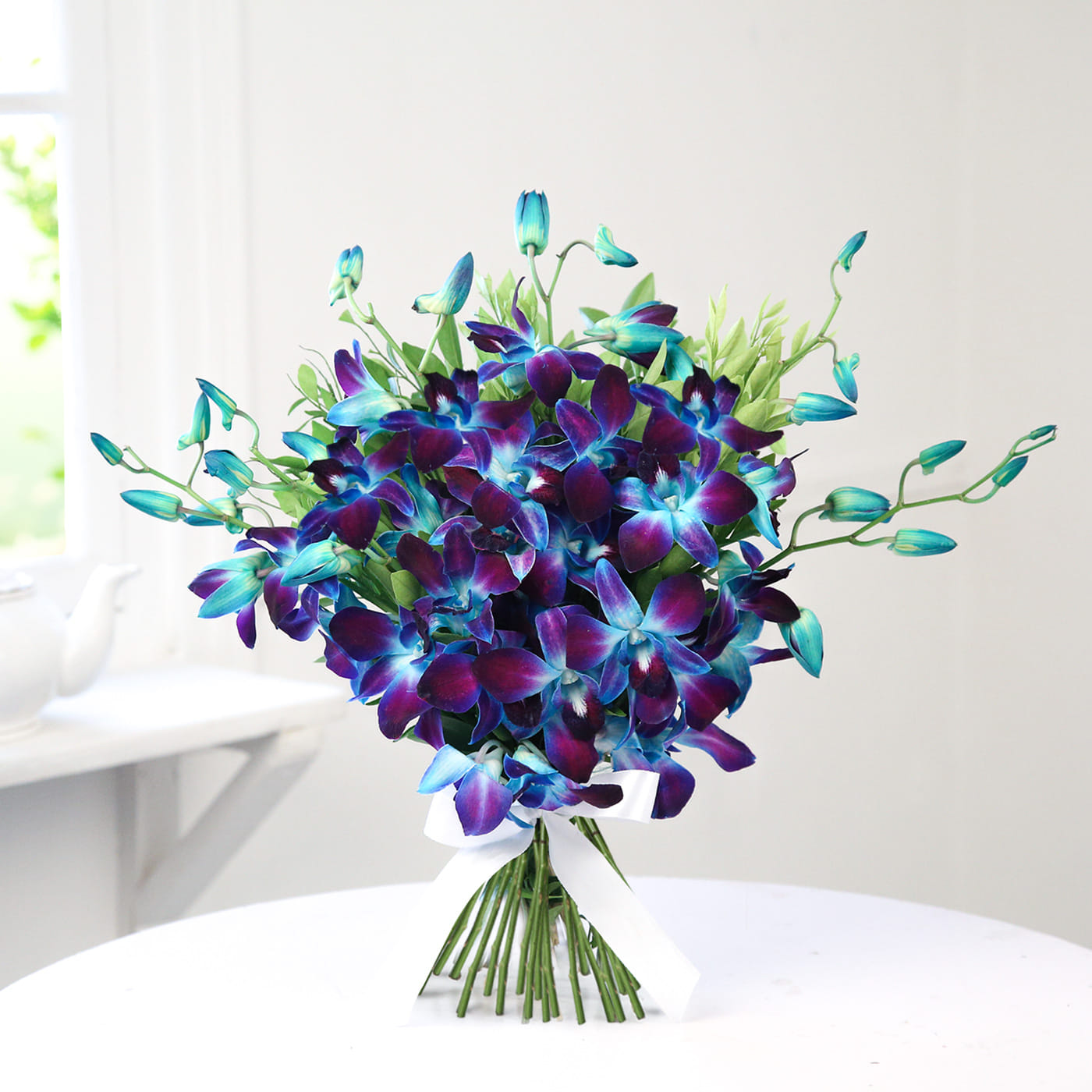 of a delicious round chocolate cake and a flower arrangement of