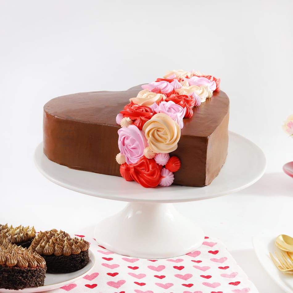 Heart-shaped cake decorated with pink icing and frosting