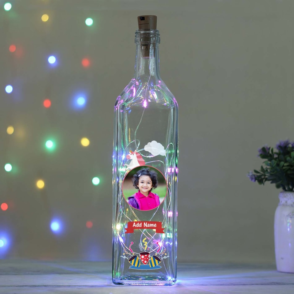 A bottle of alcohol and a gift on a light background Stock Photo - Alamy