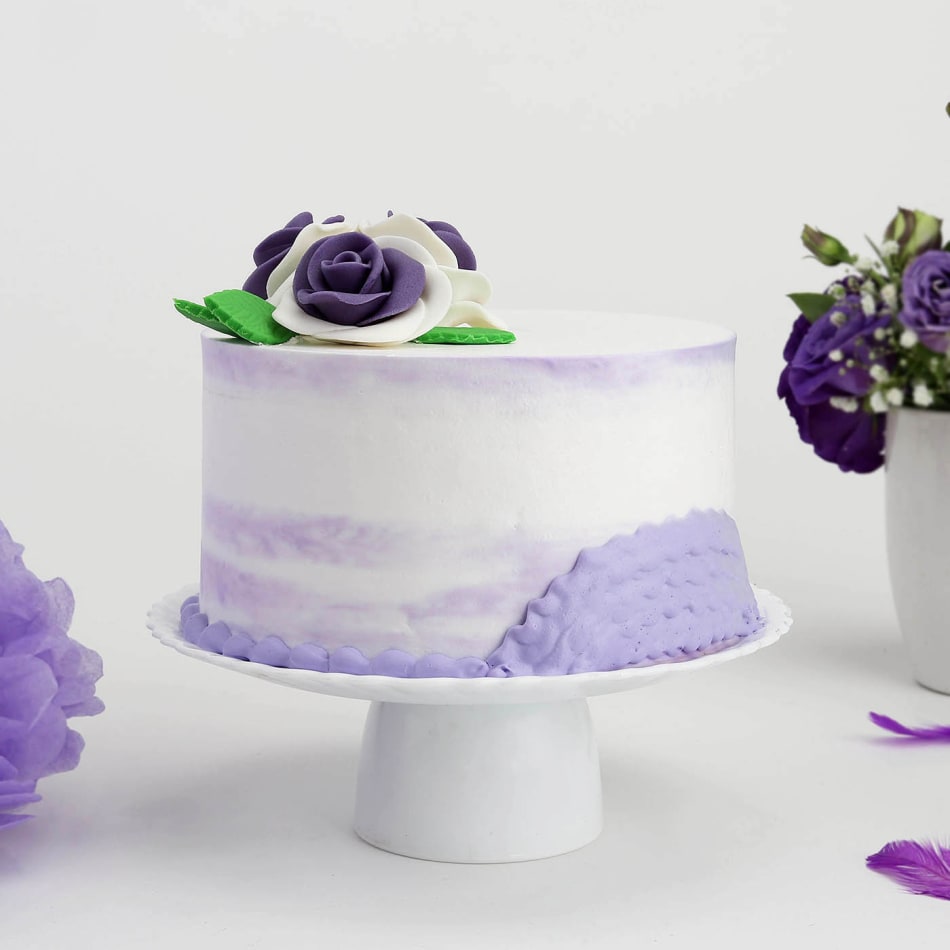 Purple drip cake with sprinkles and mini choco bars - FunCakes