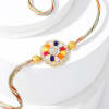 Buy Enchanting Navratna Rakhi And Gulab Jamun Combo