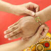 Shop Ganesha Rakhi with Meena Work & Golden beads