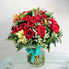 Red roses and seasonal flowers in vase Online