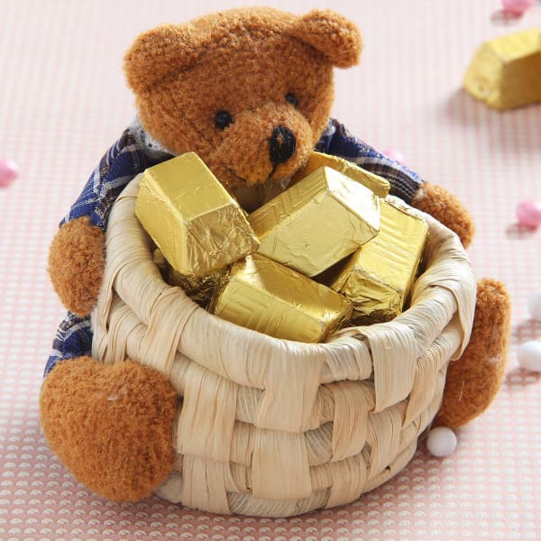 teddy bear holding chocolate