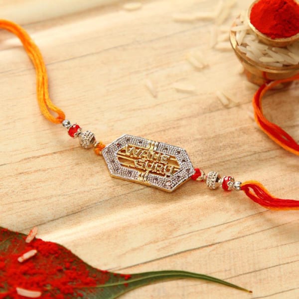 Divine Wahe Guru Stone Studded Rakhi: Gift/Send Rakhi Gifts Online ...