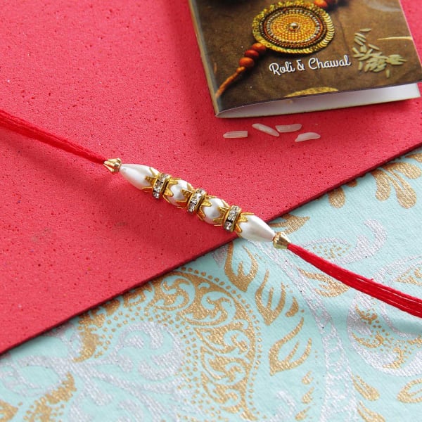 Elegant Pearl Rakhi with Doda Barfi sweets and roli chawal ...