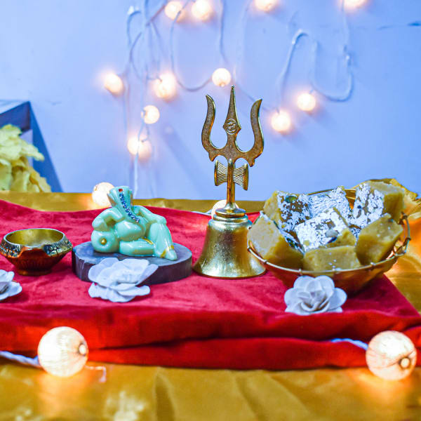 Ganesha Idol with Sweets and Pooja Essentials