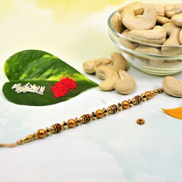 Golden Beads Rakhi With Cashew