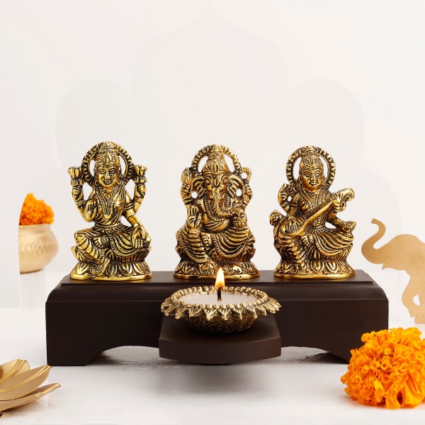 Laxmi, Ganesha, And Saraswati Metal Idol With Diya