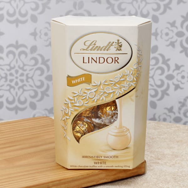 Lindt Lindor White Chocolate with Set of 3 Om Rakhi Gift/Send Rakhi