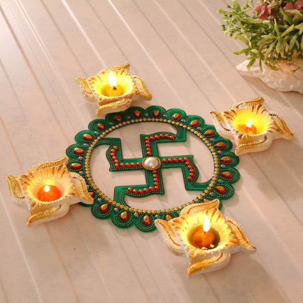 Set Of 4 Clay Diyas With Decorative Swastik And Sweets Gift Send