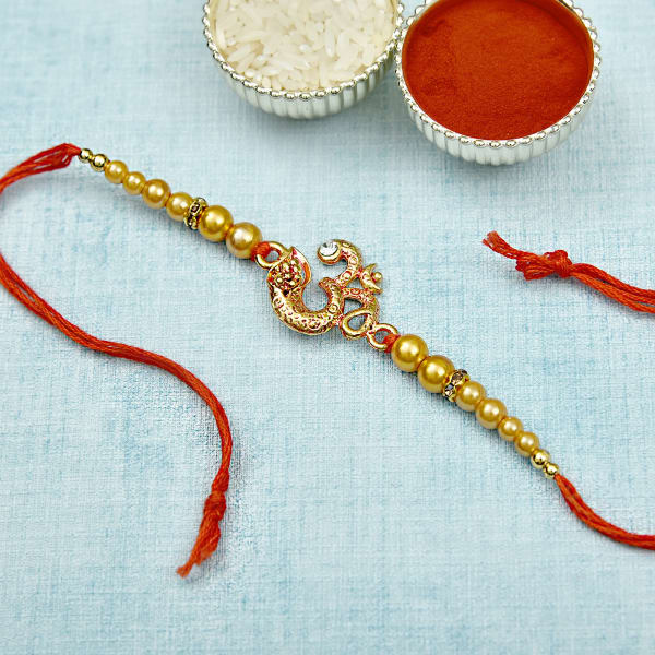 Silver Om Rakhi with CZ stones and Pearls: Gift/Send Rakhi Gifts Online ...