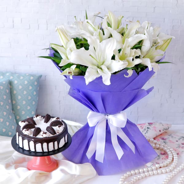 White Lilies Arrangement in Blue Wrapping with Black Forest Cake (Half Kg)