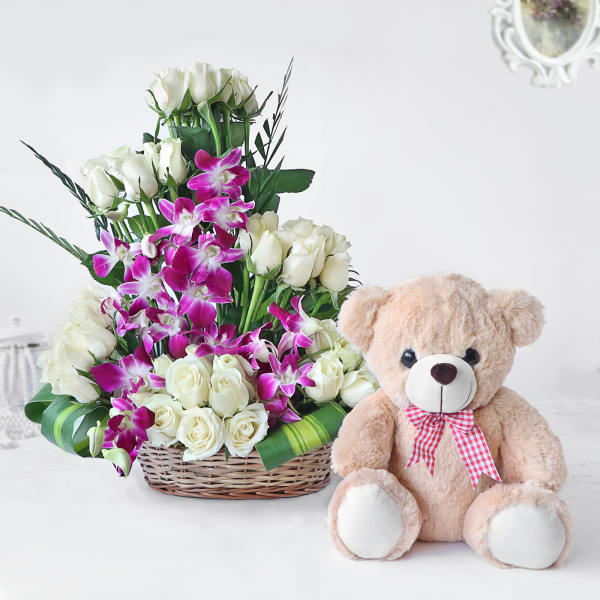 White Roses and Orchids in Cane Basket with Teddy Bear