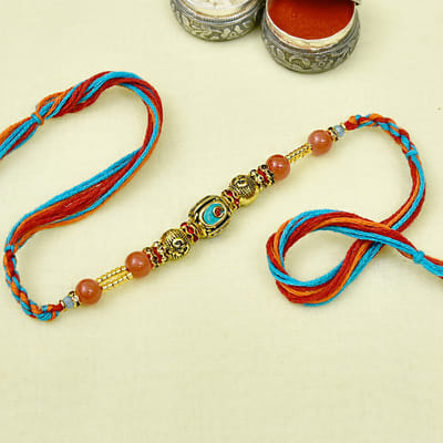 Antique Finish Om Beads and Colorful Stone Embellished Rakhi