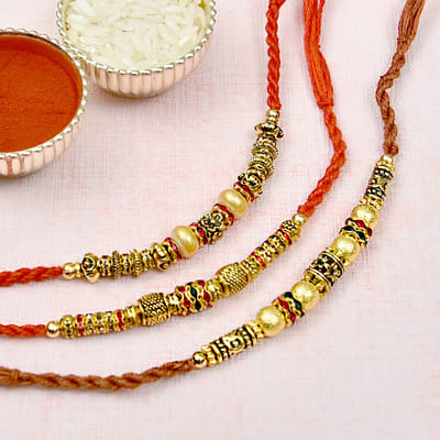 Antique Metal Rakhi Set of Three Embellished with Multicolor Stones