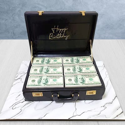 Cake a suitcase with a man from sugar paste. On birthday Stock Photo - Alamy