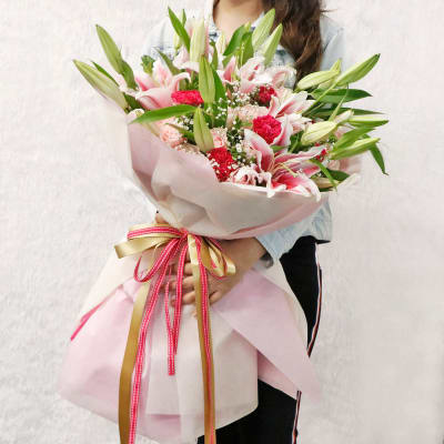 Buy/Send Pink Lily Roses & Carnations Arranged in a Ribbon Bouquet ...