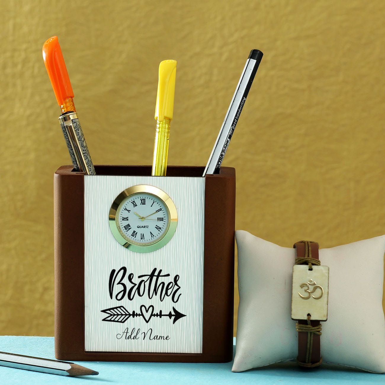 Om Bracelet Rakhi with Personalized Pen Stand with Clock